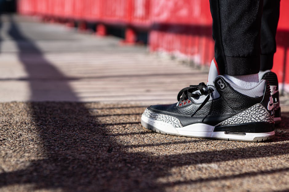 Black and white sneaker on a sunny walkway showing urban street style.