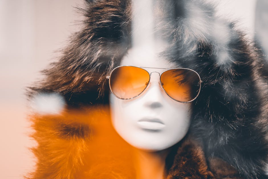 A mannequin wears aviator sunglasses and a fur coat, exuding winter fashion vibes.