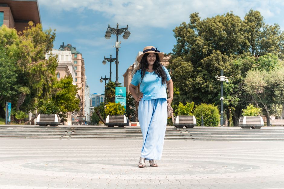 A young woman enjoying a sunny day on Baku Boulevard, showcasing the urban lifestyle and scenery.