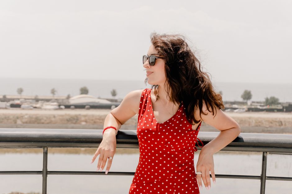 Confident woman in sunglasses enjoying a sunny day near the Caspian Sea in Baku, Azerbaijan.