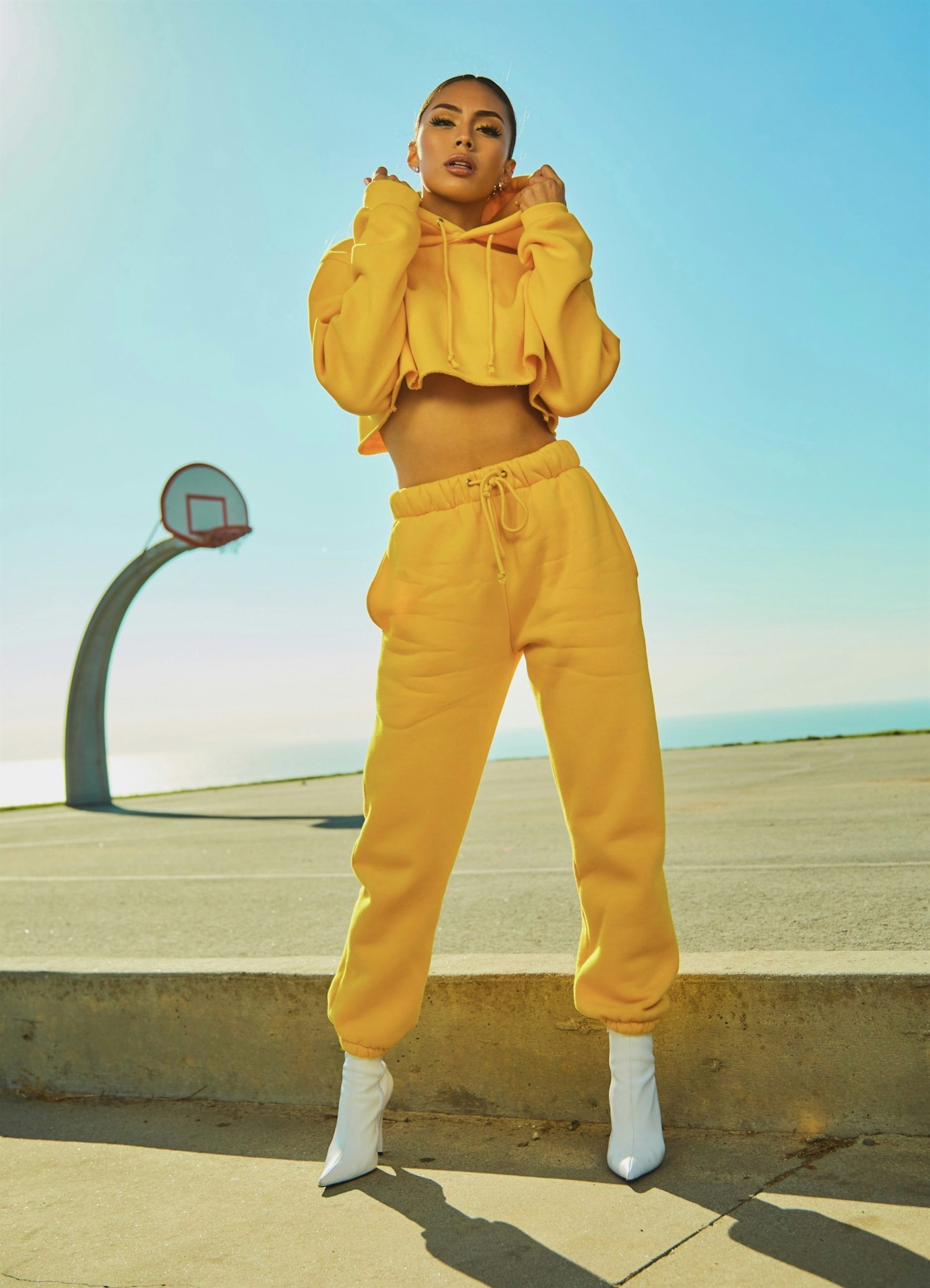 Bold yellow streetwear outfit in a fashion editorial setting